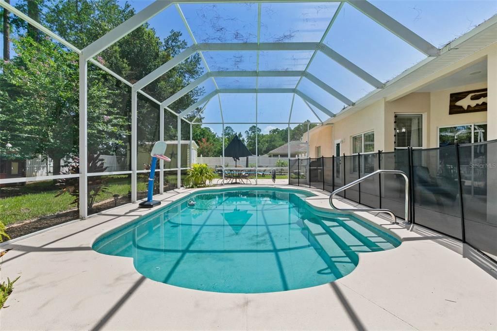 Screened in lanai and pool with removable child safety barriers.