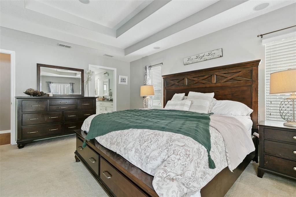 Beautiful primary bedroom with custom trey ceilings.