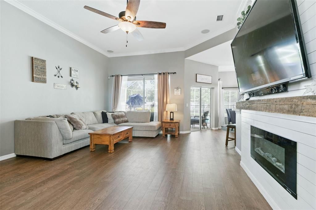 Large living room open to kitchen, with sliders to Pool