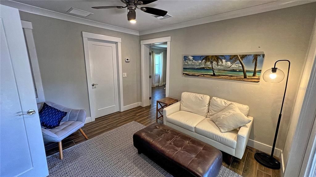 Off the dining area is this sitting room with large custom closet leading into 2nd suite