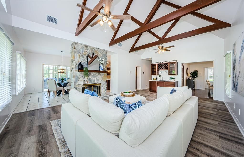 Last view from the back of the family room showing fireplace, wet bar, entry to kitchenette.