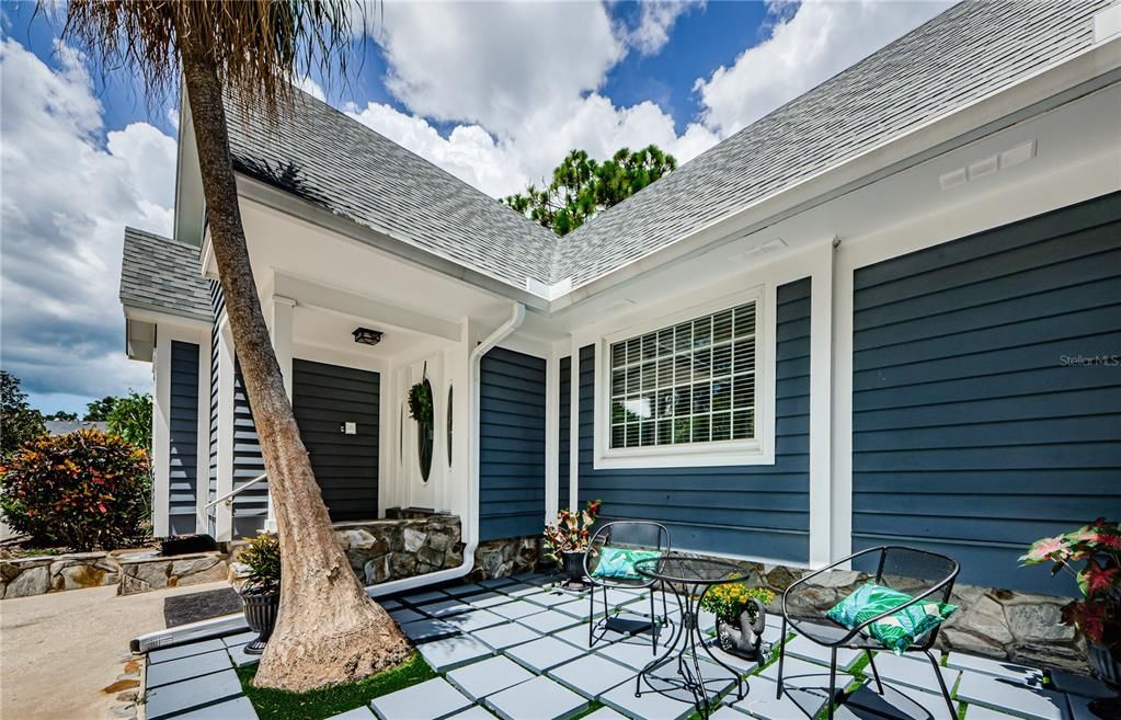 Front entrance door and patio outside.