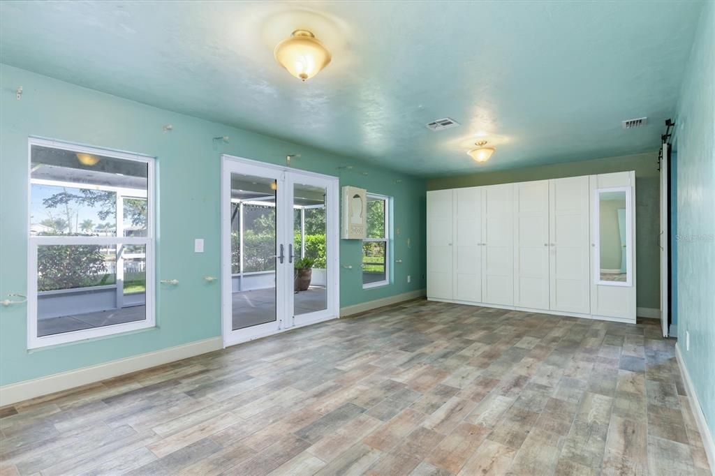 View from rear towards front dining area and French doors leading to screened front porch.