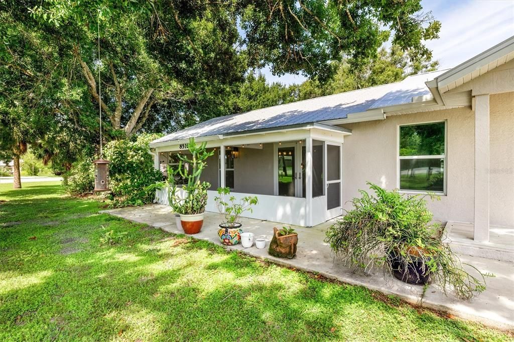 Screened front porch and additional concrete patio.