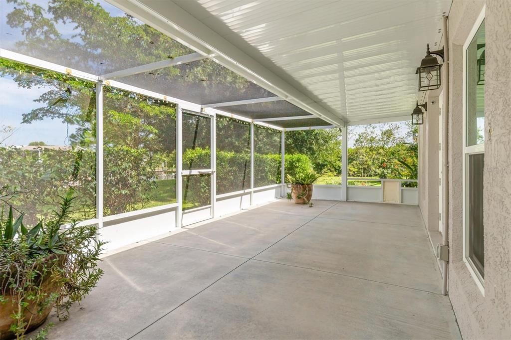 Extended screened lanai by Primary Bedroom with separate screened door leading to backyard and waterfront.