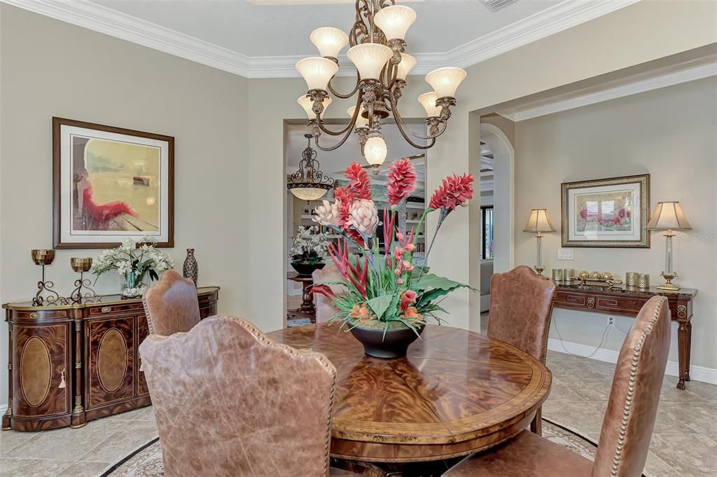 The dining room features plantation shutters, double crown molding, and large open dining.