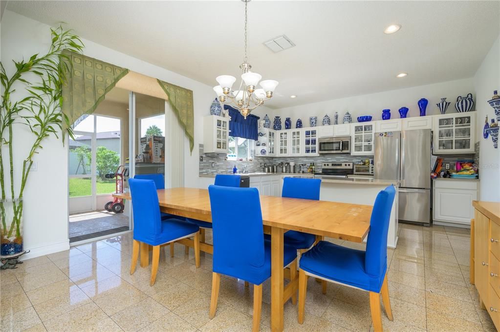 Eat in Area  with Sliding Door access to Screened Patio. Granite tile flooring continues through kitchen laundry and bath area to garage.