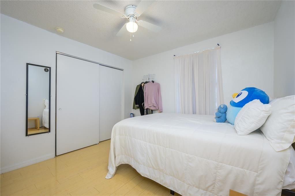 Bdrm 4 view 1 with nice closet space, window, lighted ceiling fan,and bamboo flooring