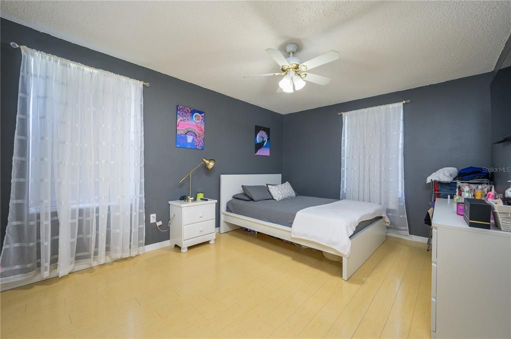 Bdrm 2 view - with  lighted ceiling fan, plenty of light and bamboo flooring.