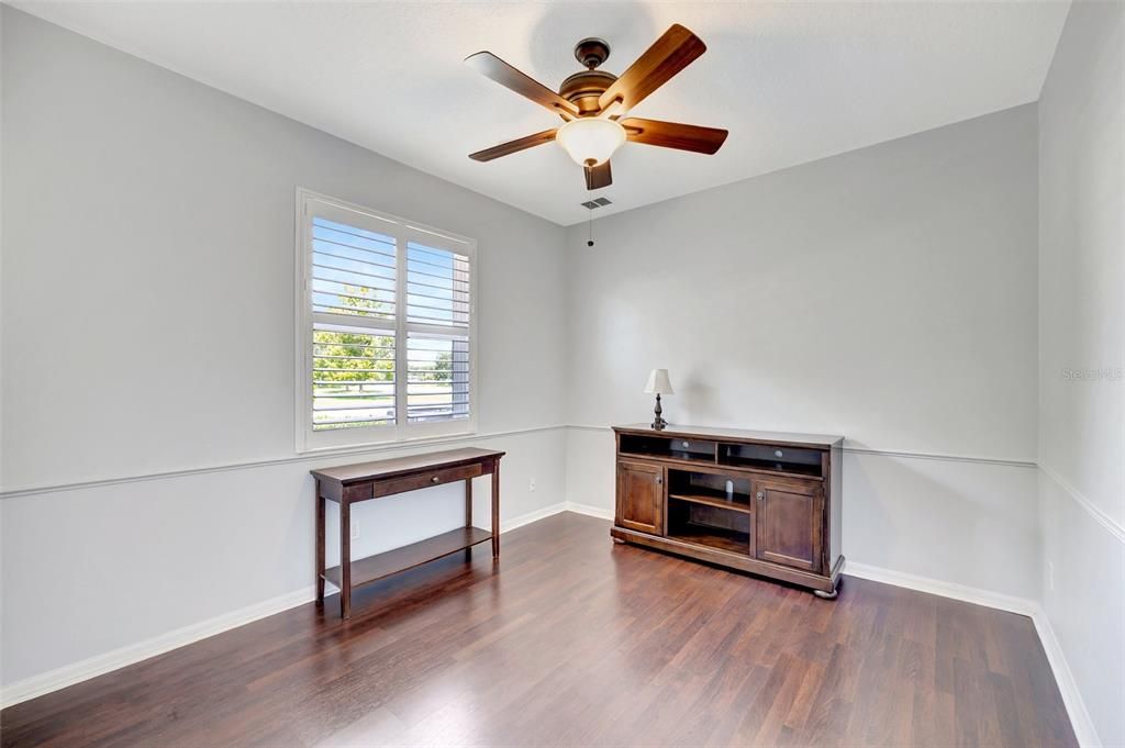 Bedroom #3 also features laminate wood floors and ceiling fan