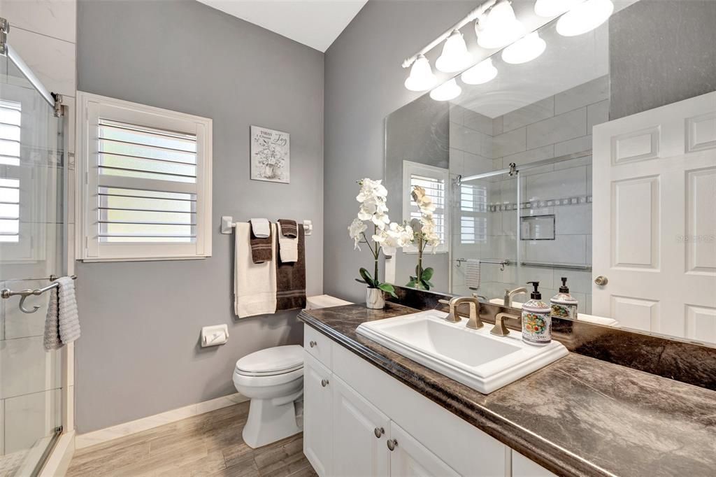 Guest bath with tile floors and single vanity