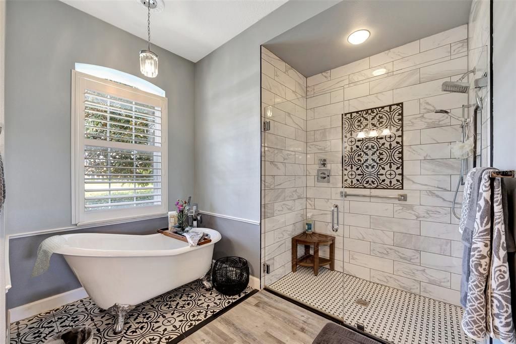 Stunning spa like primary bath. Walk in shower with floor to ceiling tiles.