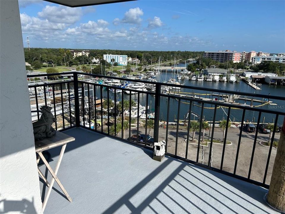 Wrap around balcony overlooks river & city marina!