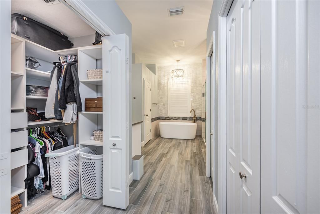 Walk-in closet with custom shelving in the primary bathroom.