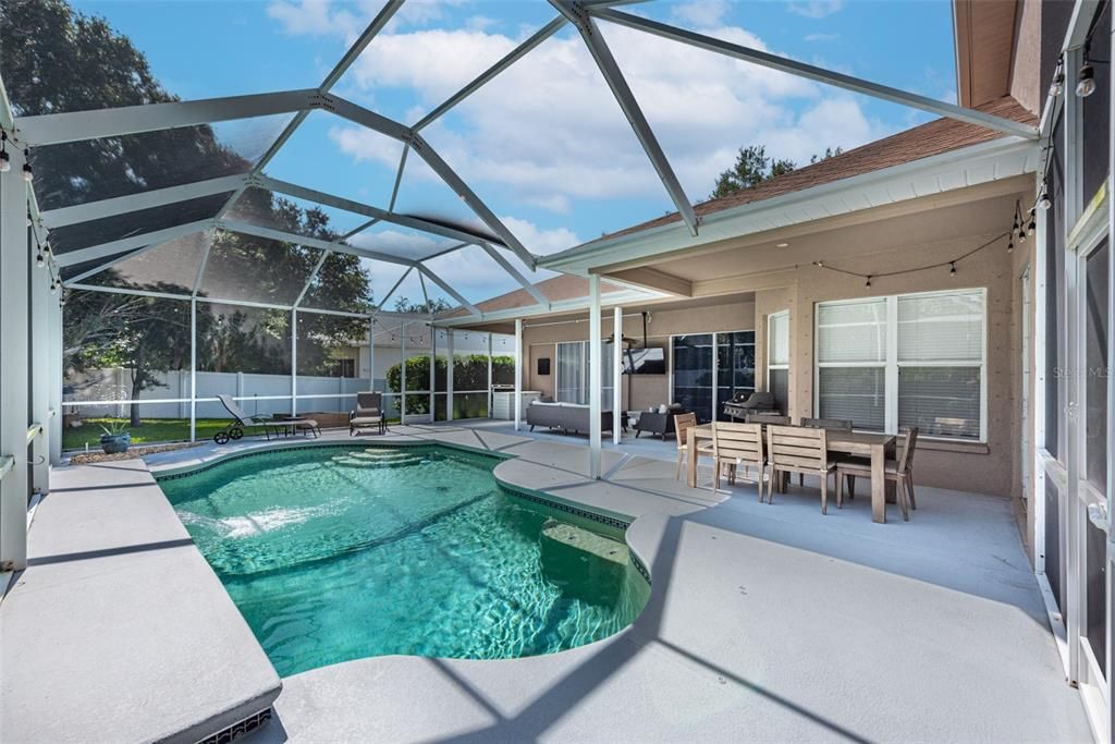 Extended covered & screened lanai with a relaxing heated pool to melt your troubles away.