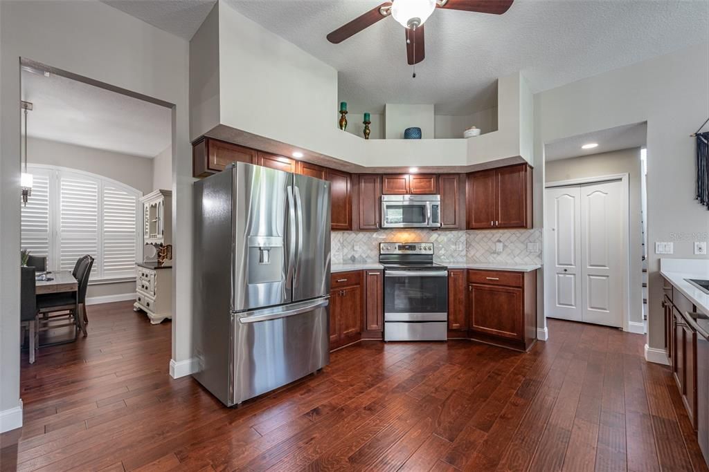 Upgraded Kitchen appliance are stainless steel and the range has convection heating.  Stylish marble tile backsplash set in a diagonal herringbone pattern.