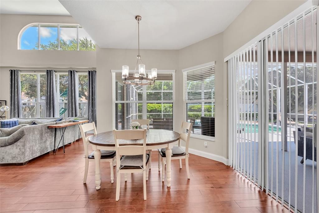 Separate dinette area off the kitchen and family room with views of the covered lanai and pool.