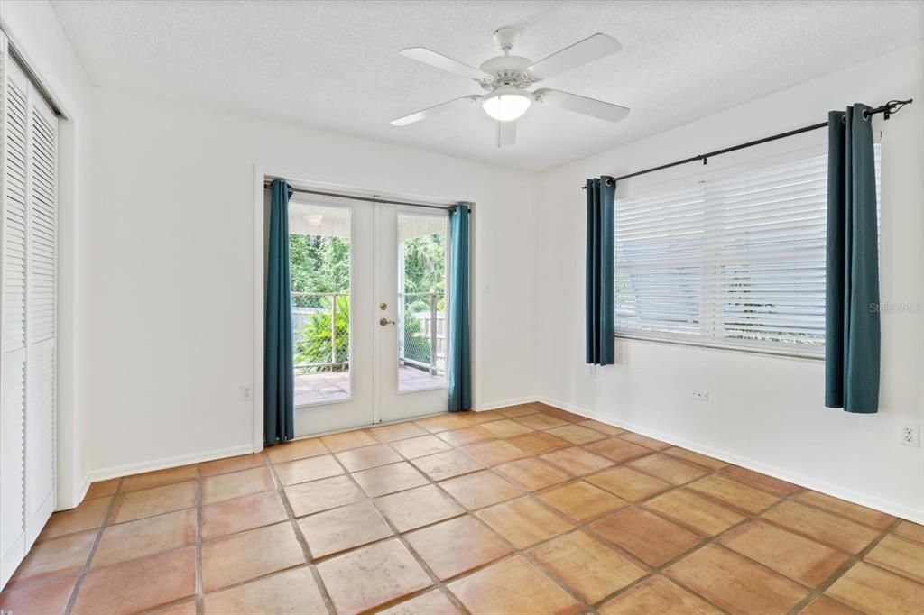 Bedroom 2 with french doors to back lanai and privacy fenced-in back yard