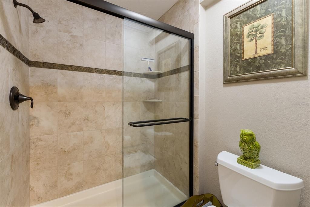 Primary bathroom w/ glassed in shower