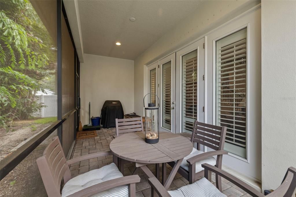 french doors open to a screened back patio