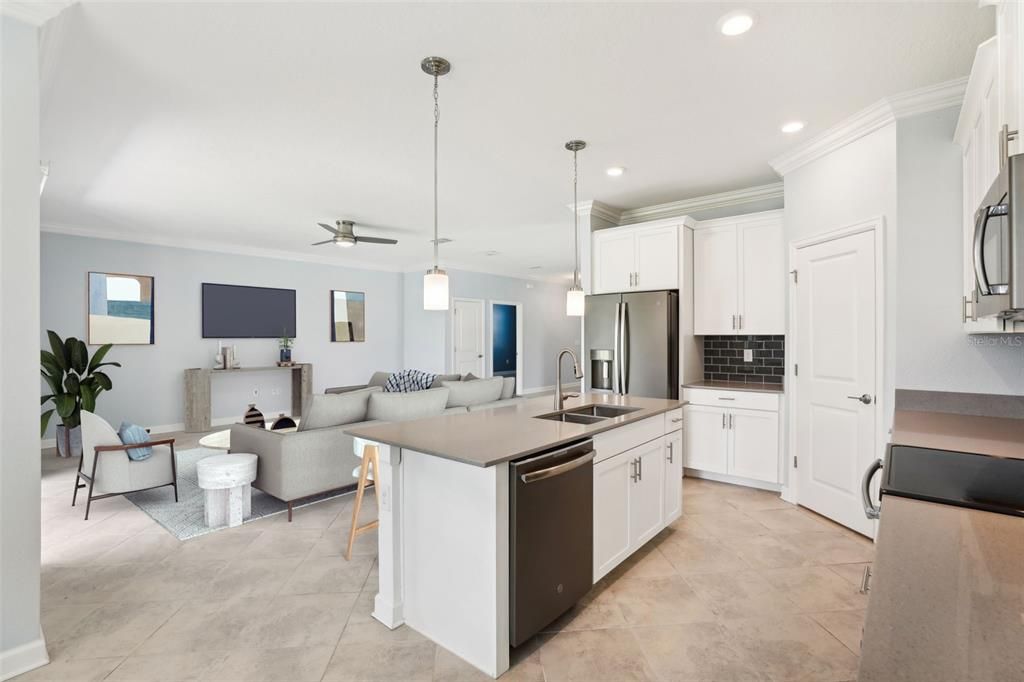 The Kitchen has STONE COUNTERTOPS, an OVERSIZED ISLAND, STAINLESS STEEL APPLIANCES, UPGRADED CABINETRY and BEAUTIFUL TILE BACKSPLASH.