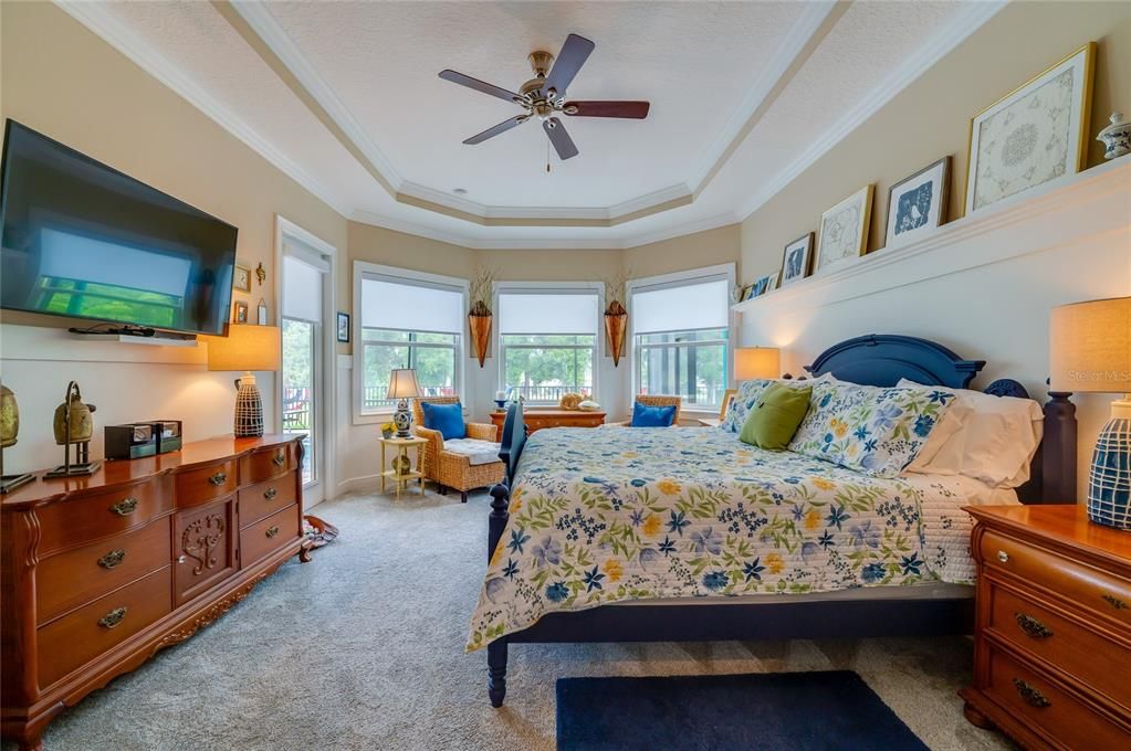 Large primary bedroom overlooking the pool