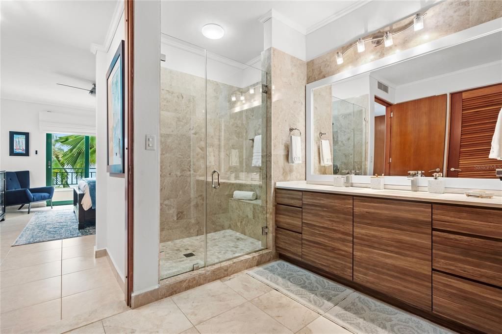 Primary bathroom- marble shower with build in bench