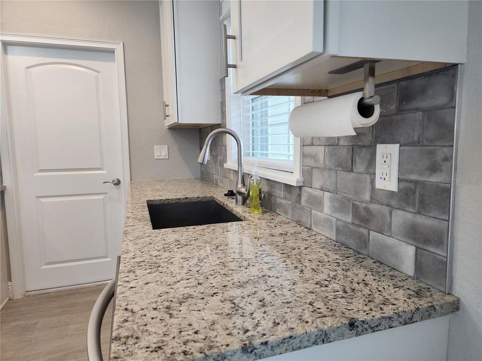 Kitchen with door leading into the 2-car garage