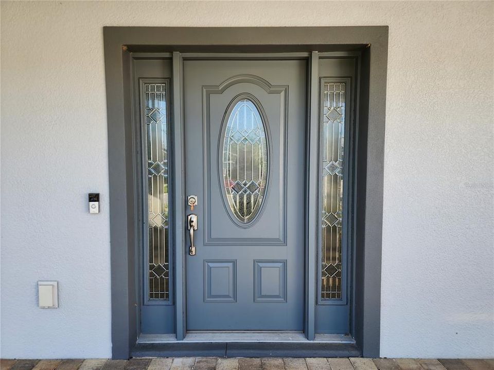 Front door with matching sidelights and decorative leaded glass