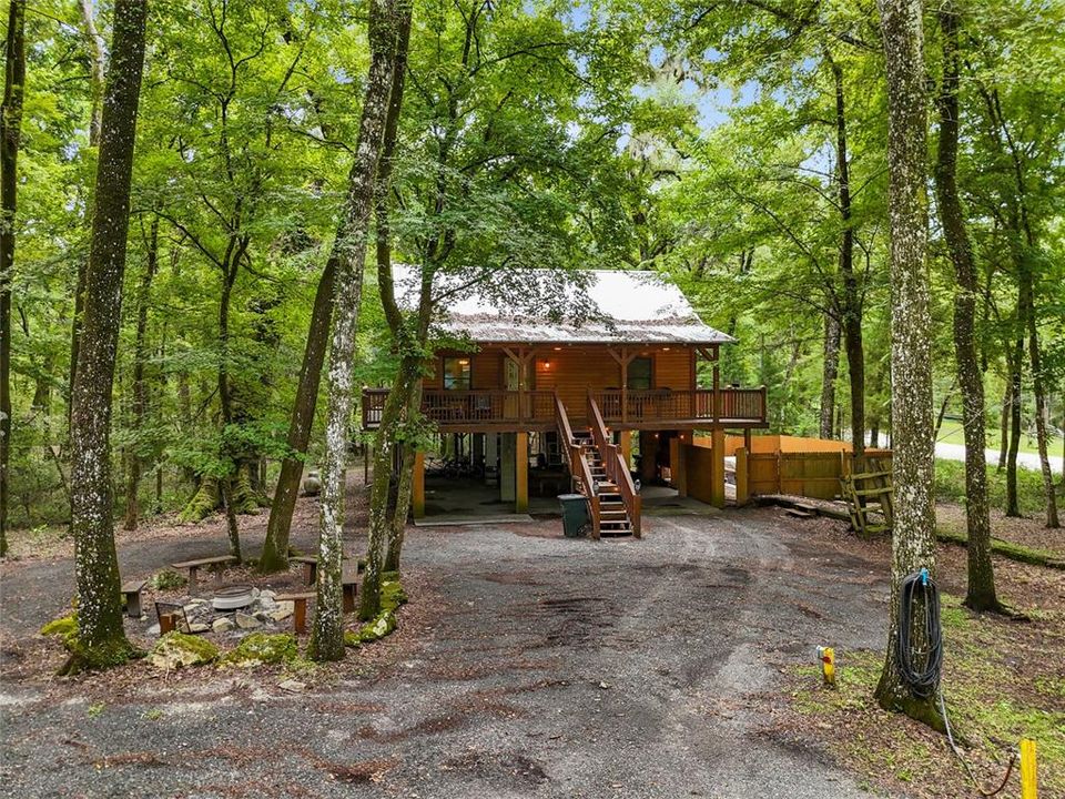 hot tub with privacy fence to the right of the cabin