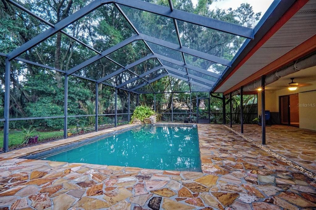 Pool and lanai with waterfall at one end