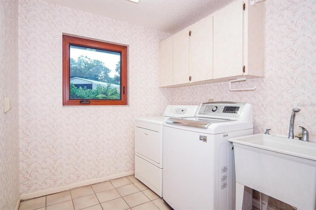 Laundry room has a storage closet behind the door.