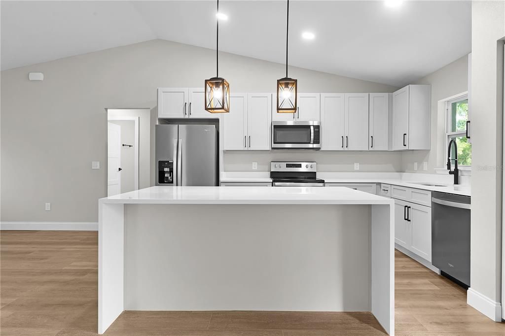 Kitchen island with waterfall quartz countertop