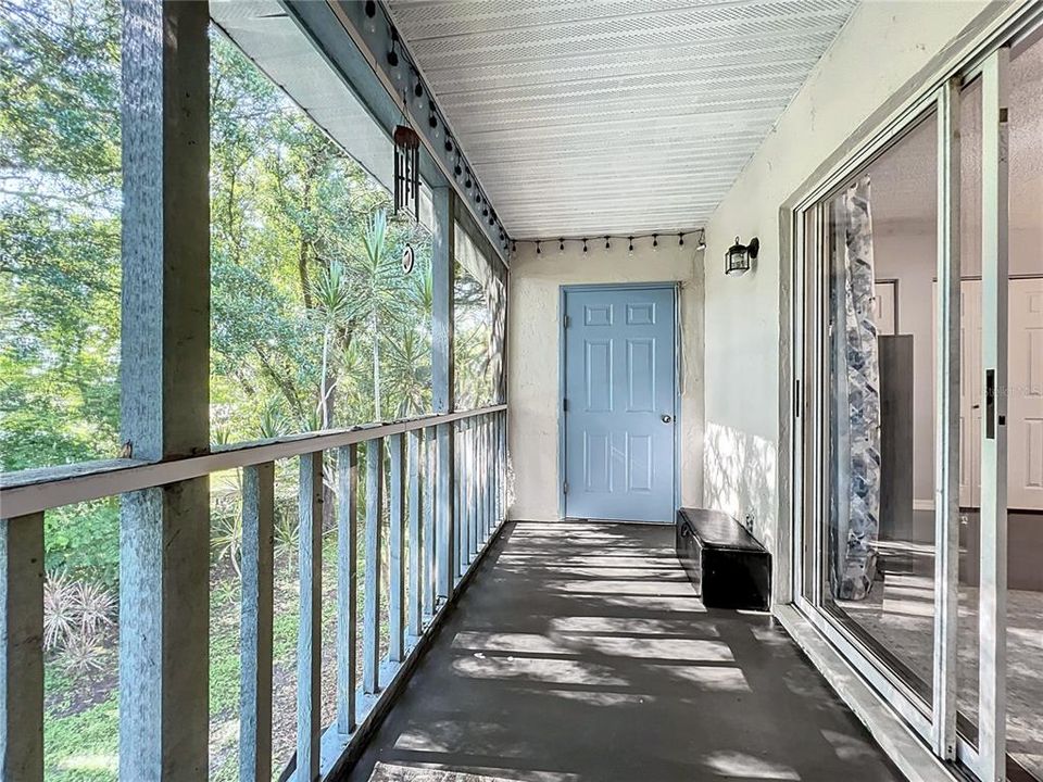 Upstairs screen balcony with additional storage room.