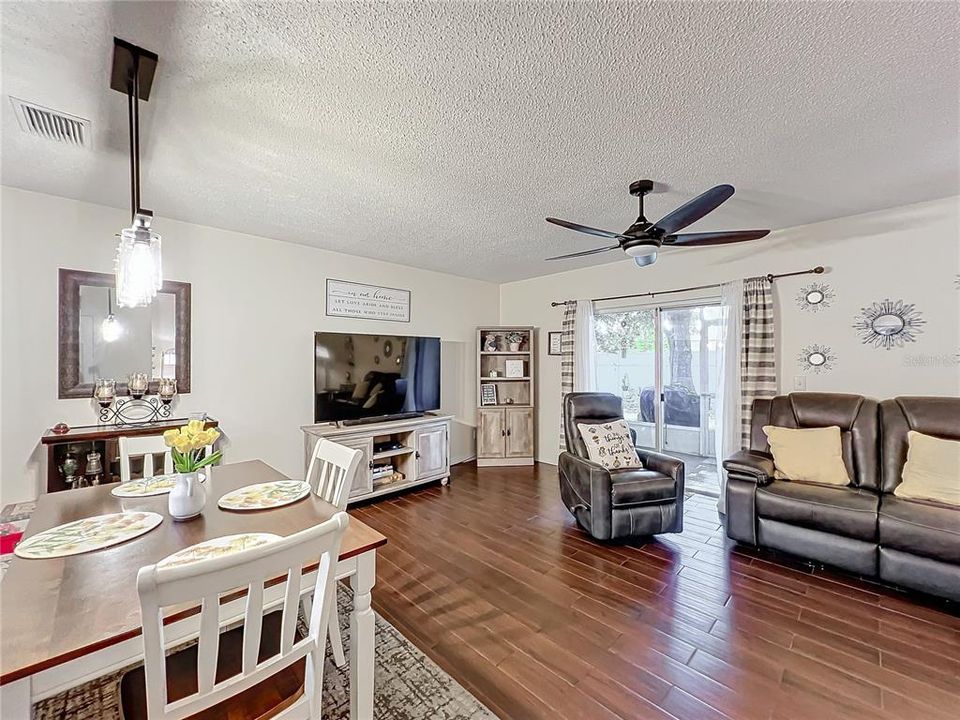 Spacious living room with exit to the screened outdoor lanai.