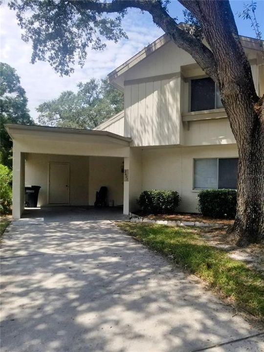 2 story exterior with attached carport, long driveway