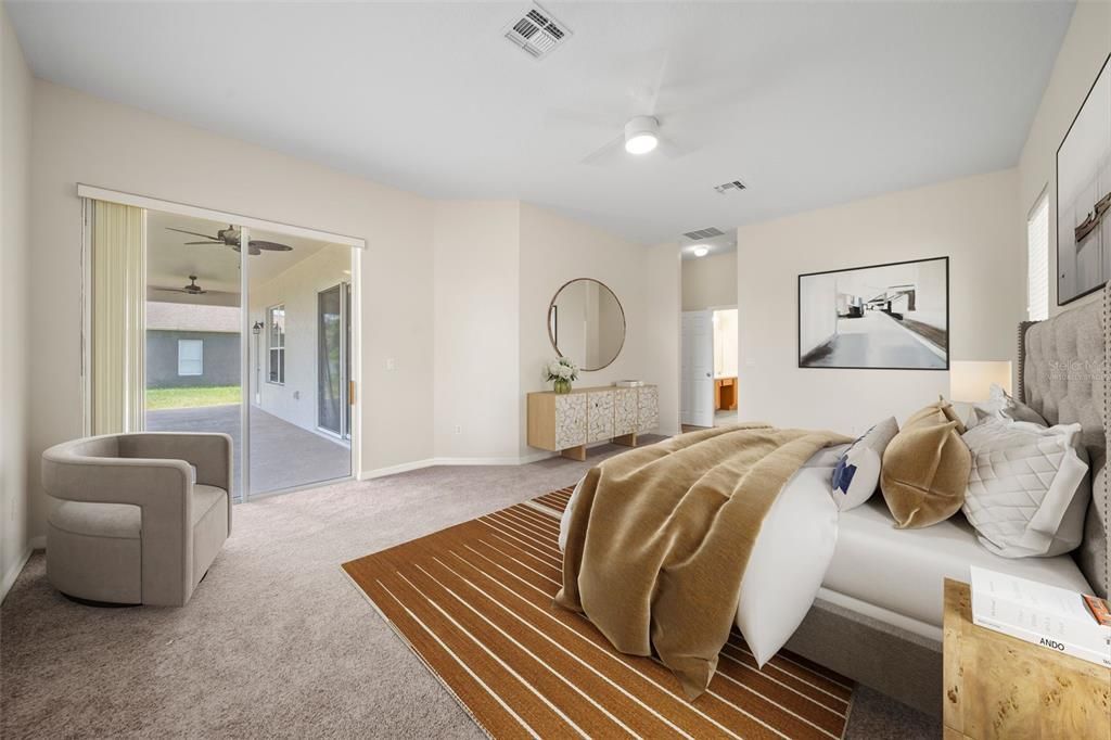 Virtually staged master bedroom is conveniently located on the first floor with its own private access to the lanai patio.