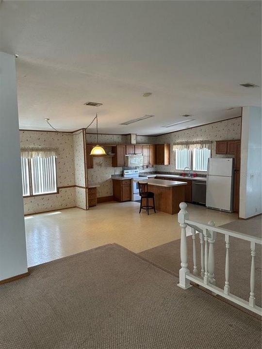 looking into the kitchen and dining room.