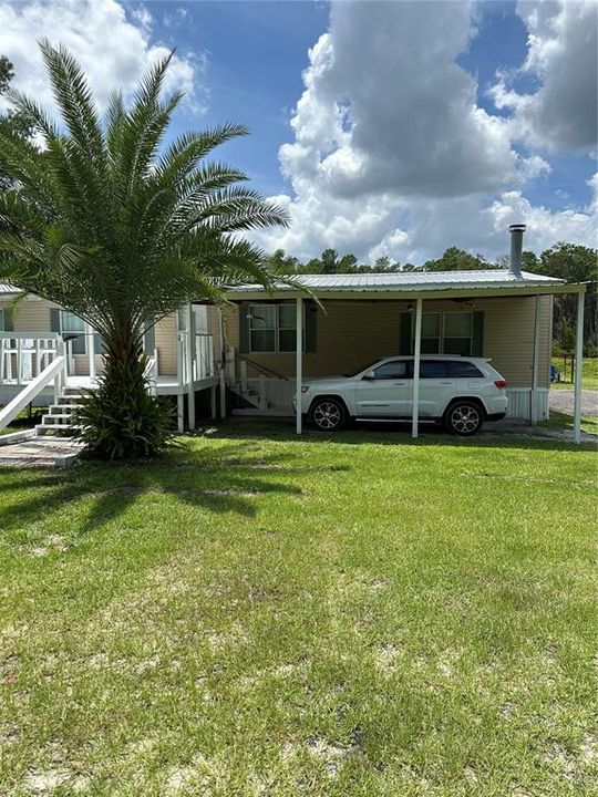 carport has plenty of room for your ride or toys.