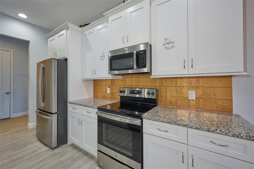 Kitchen has granite countertops, soft-close drawers and stainless steel appliances.