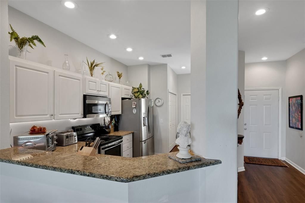 Nicely proportioned kitchen with granite and stainless steel appliances.