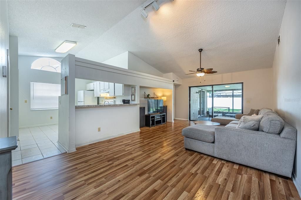 Soaring 12 foot ceilings create an airy and open ambiance and hard-wearing laminate wood grained flooring in the living room.