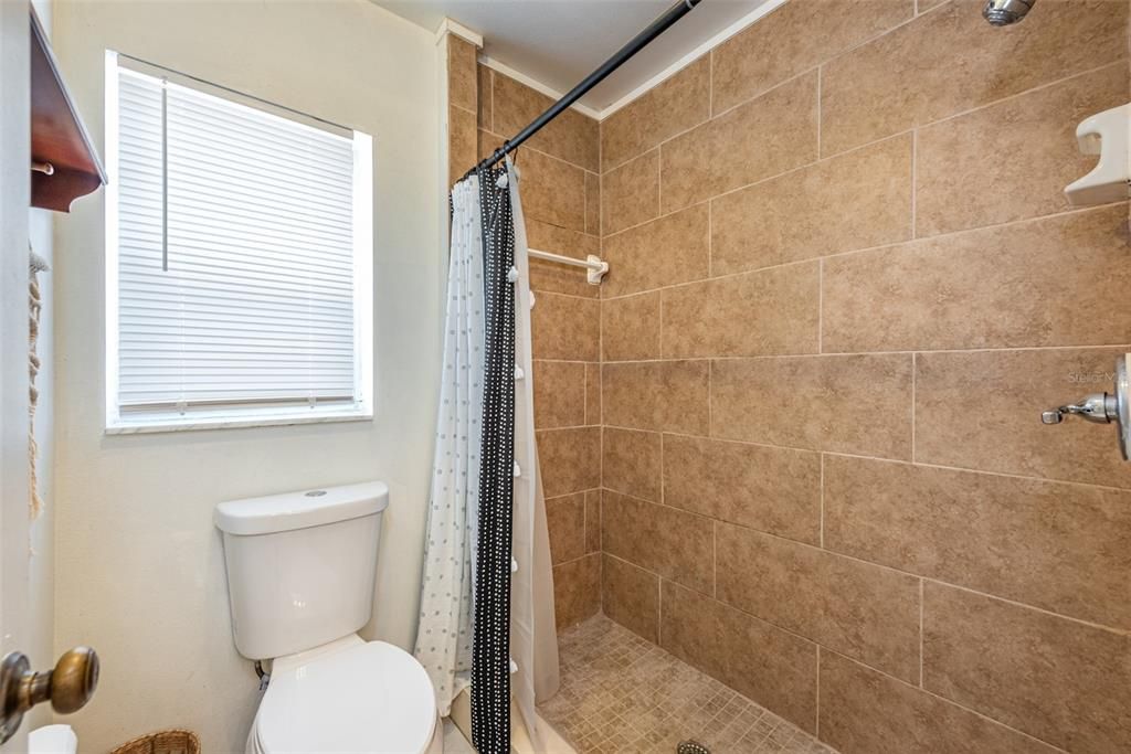 The owner’s en-suite large shower with floor to ceiling large format tile.