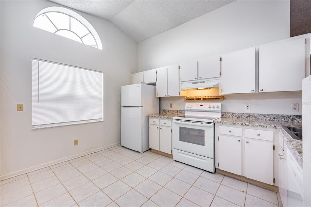 Large transom window in Kitchen lets the natural light flood the area.  There is room for a small dining table under the window or a central island workstation.