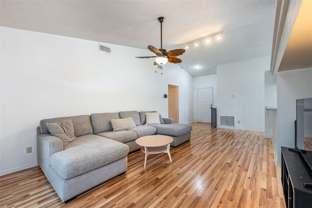 Cathedral ceilings and stylish ceiling fan in the living room.