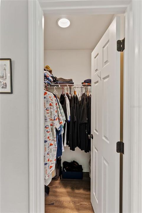 Two walk in closets across from each other.