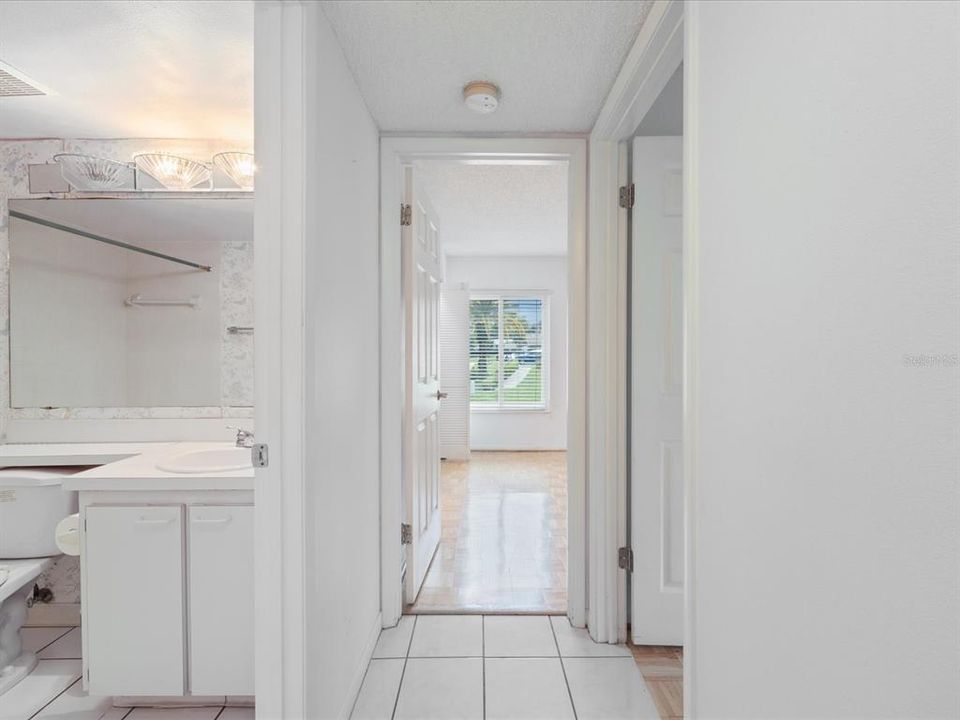 Hallway view w/ guest bathroom on left