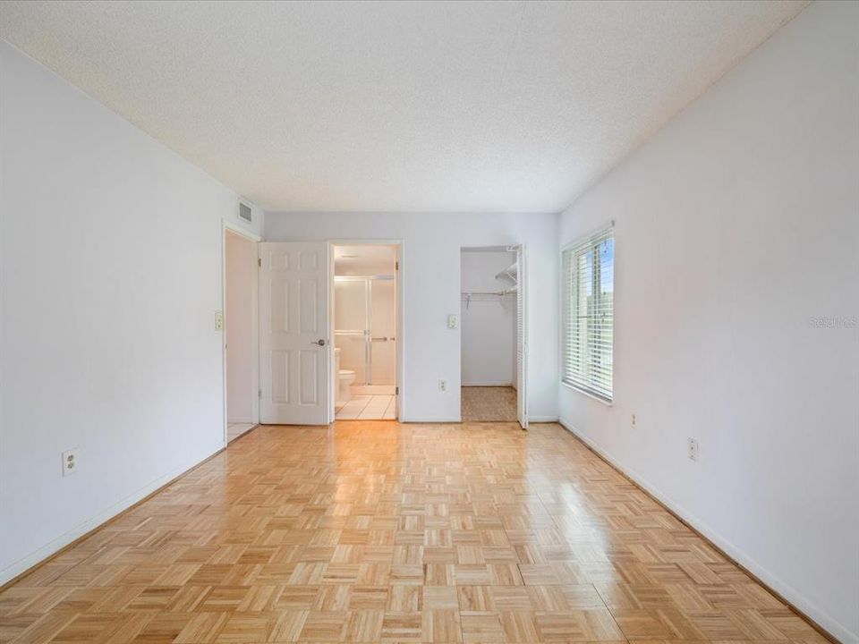 Master bedroom view of walk in closet and en-suite bathroom