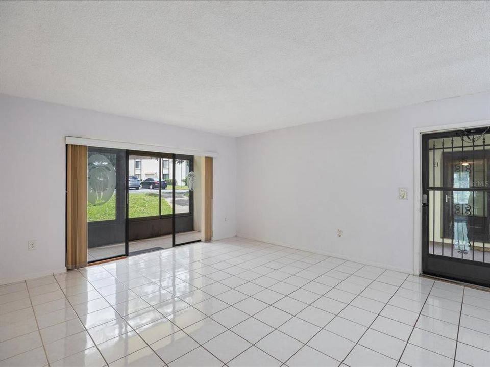 Sliding glass doors in living room lead to screened porch