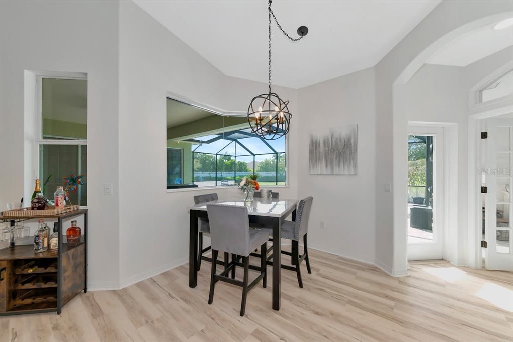 Eat in kitchen area with aquarium glass window and view of the pool.